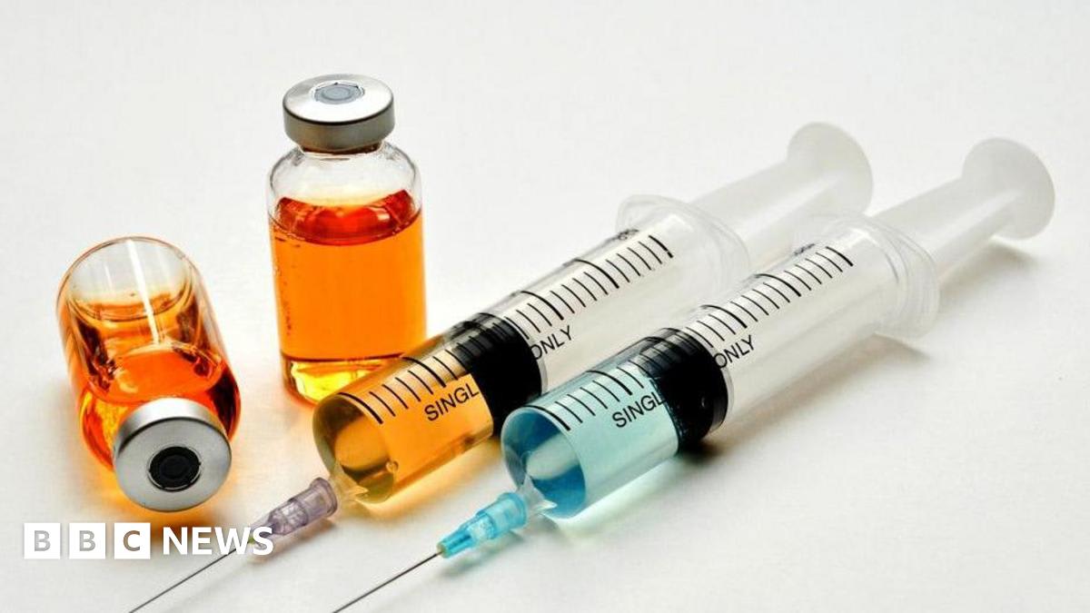 Healthcare worker preparing a quick cancer injection treatment for a patient in a hospital setting