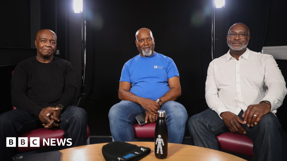 Simeon Greene standing beside healthcare display promoting prostate cancer awareness and early testing