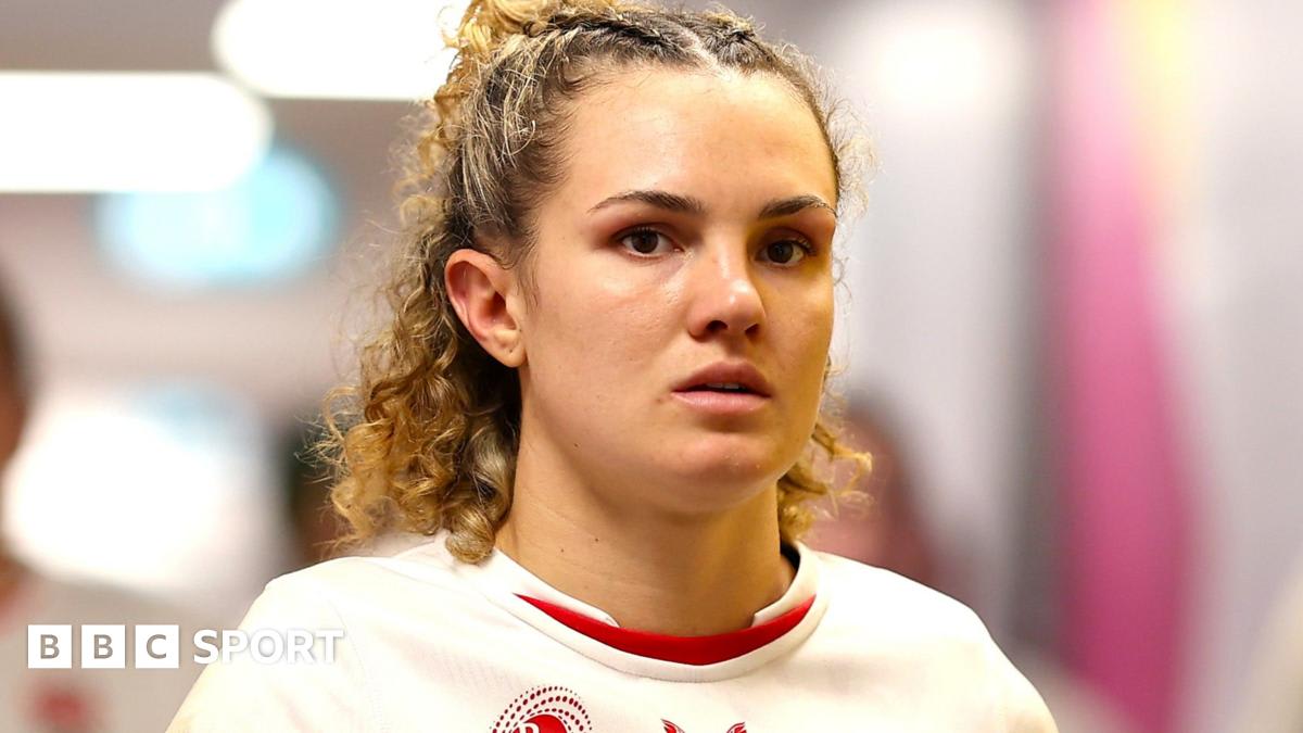 England rugby player Ellie Kildunne in red jersey celebrating during World Cup match