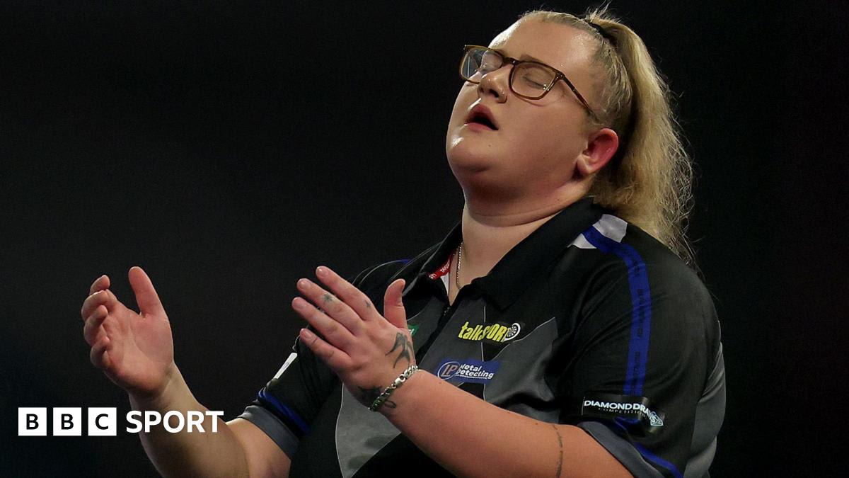 Beau Greaves competing in professional darts tournament wearing PDC women's series gear