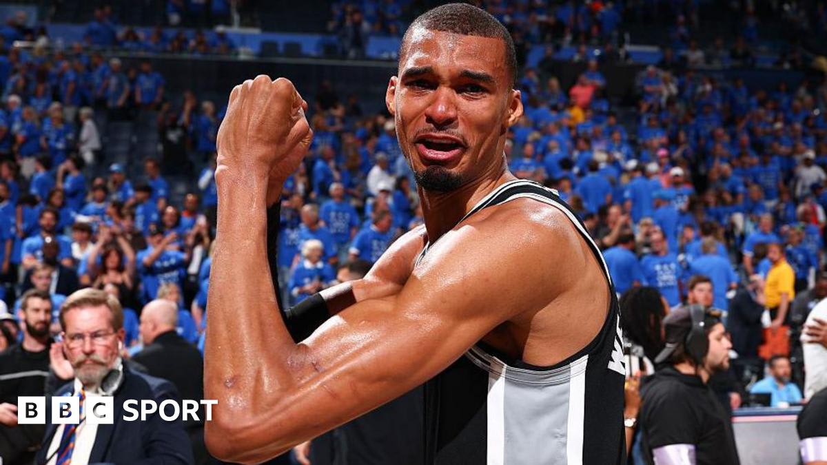 Seven-foot-five Victor Wembanyama in white San Antonio Spurs jersey playing basketball during playoff game