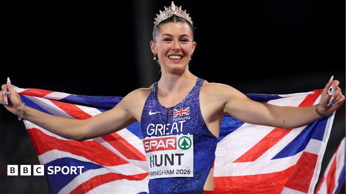 British sprinter Amy Hunt celebrates with arms raised after winning gold medal at European Championships