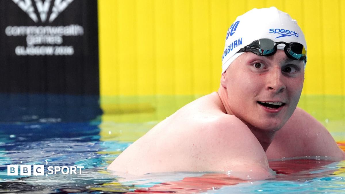 Scottish swimmer Archie Goodburn standing at poolside in competition swimwear at Commonwealth Games