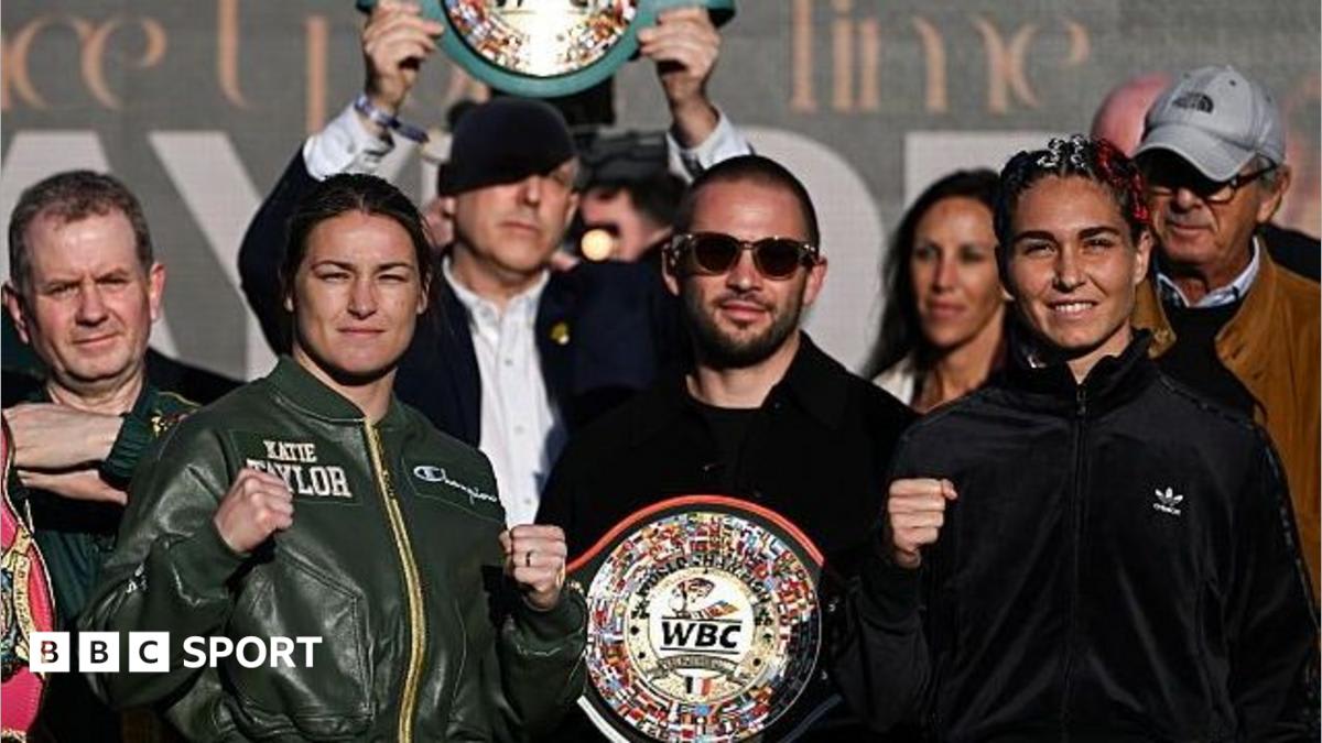 Katie Taylor stands on weigh-in scales at Trinity College Dublin surrounded by cheering fans