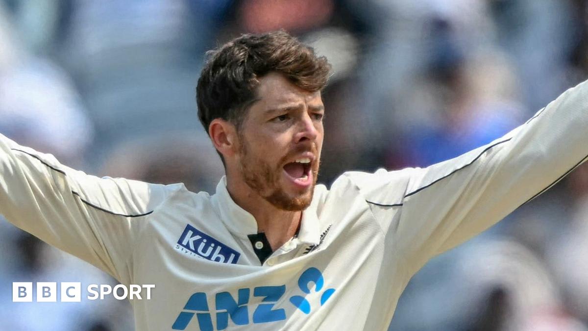 Mitchell Santner in New Zealand cricket whites preparing to bowl during international Test match