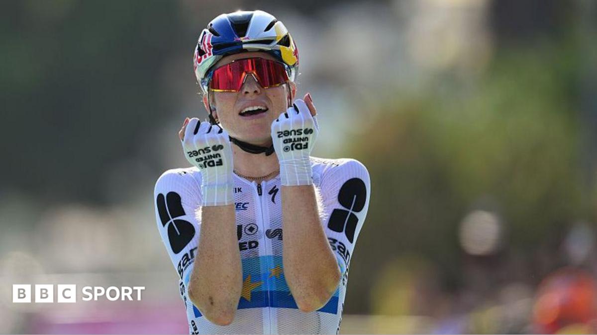 Demi Vollering celebrates crossing finish line in Nice during Tour de France Femmes stage eight