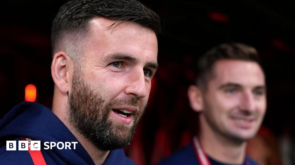 Scotland goalkeeper Liam Kelly in training gear celebrating with teammates during international duty