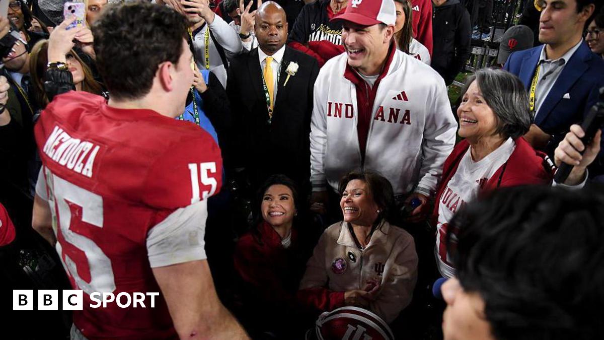 Fernando Mendoza in Indiana uniform celebrating with his mother Elsa in wheelchair on football field