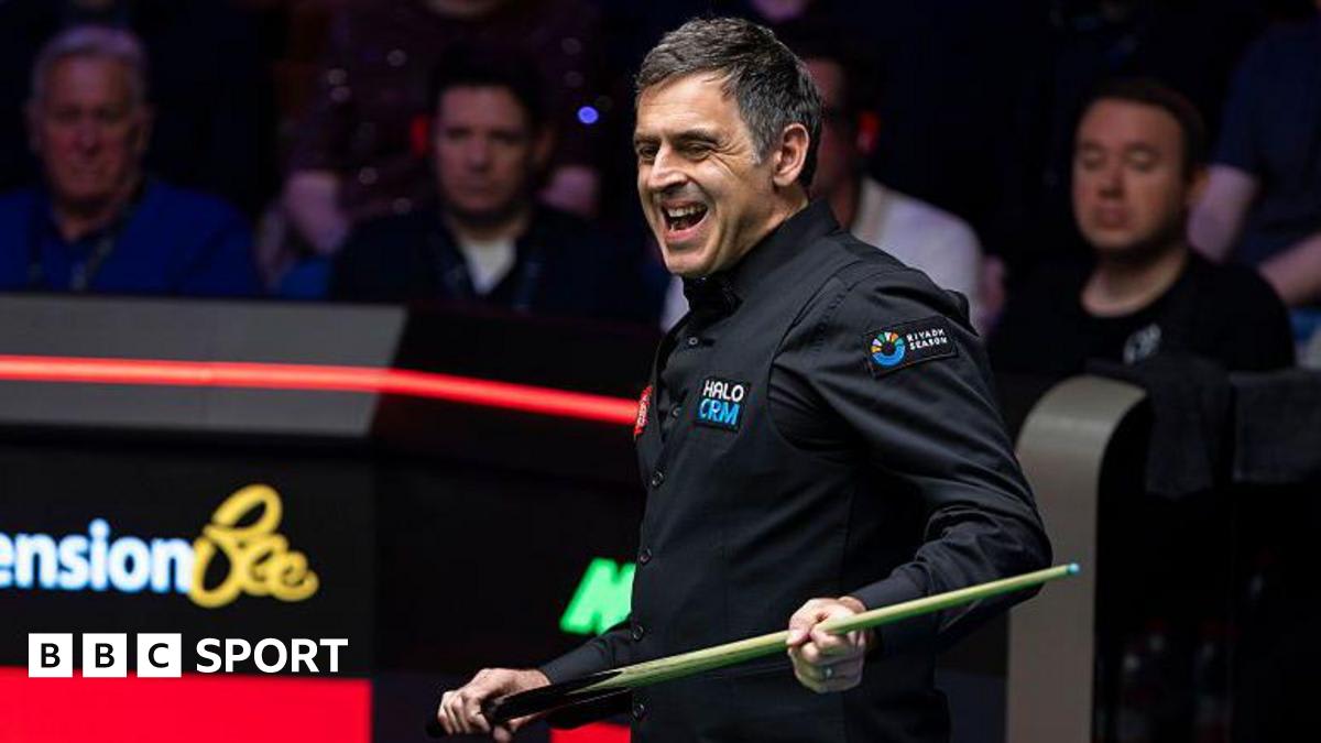 ** Ronnie O'Sullivan in concentration at snooker table during World Championship match at Crucible Theatre