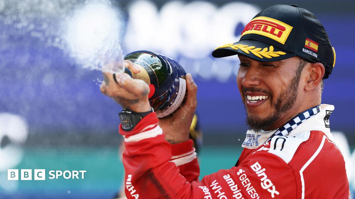 Lewis Hamilton celebrating in Ferrari racing suit after winning Barcelona Grand Prix