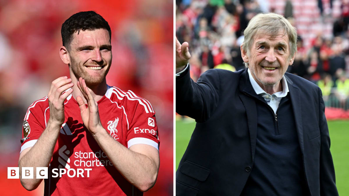 Andy Robertson in Liverpool red jersey celebrating with fans at Anfield stadium