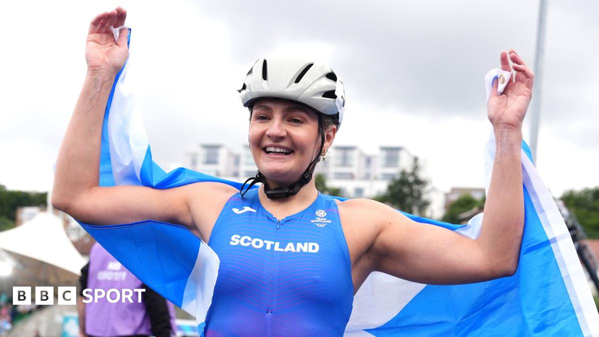 Scottish wheelchair racer Melanie Woods crossing finish line at Glasgow's Scotstoun Stadium