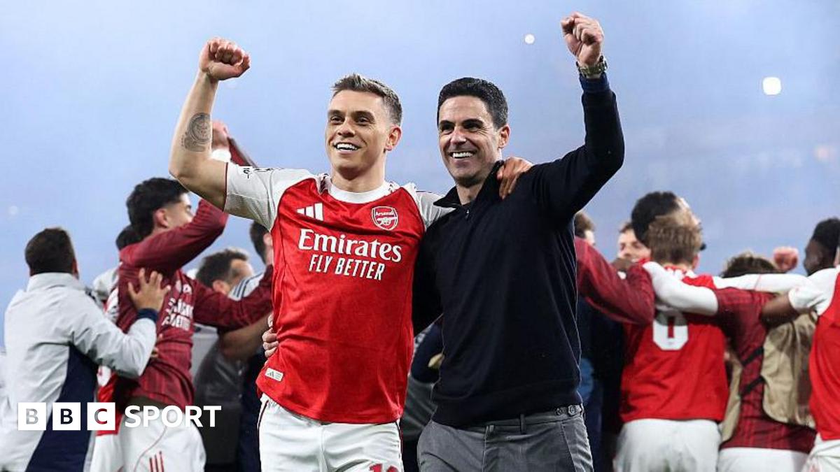 Arsenal players celebrating on the pitch after reaching the Champions League final