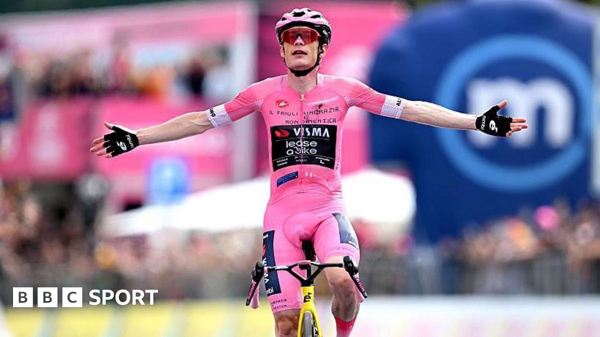 Jonas Vingegaard celebrating in yellow cycling jersey after winning mountain stage in Italy