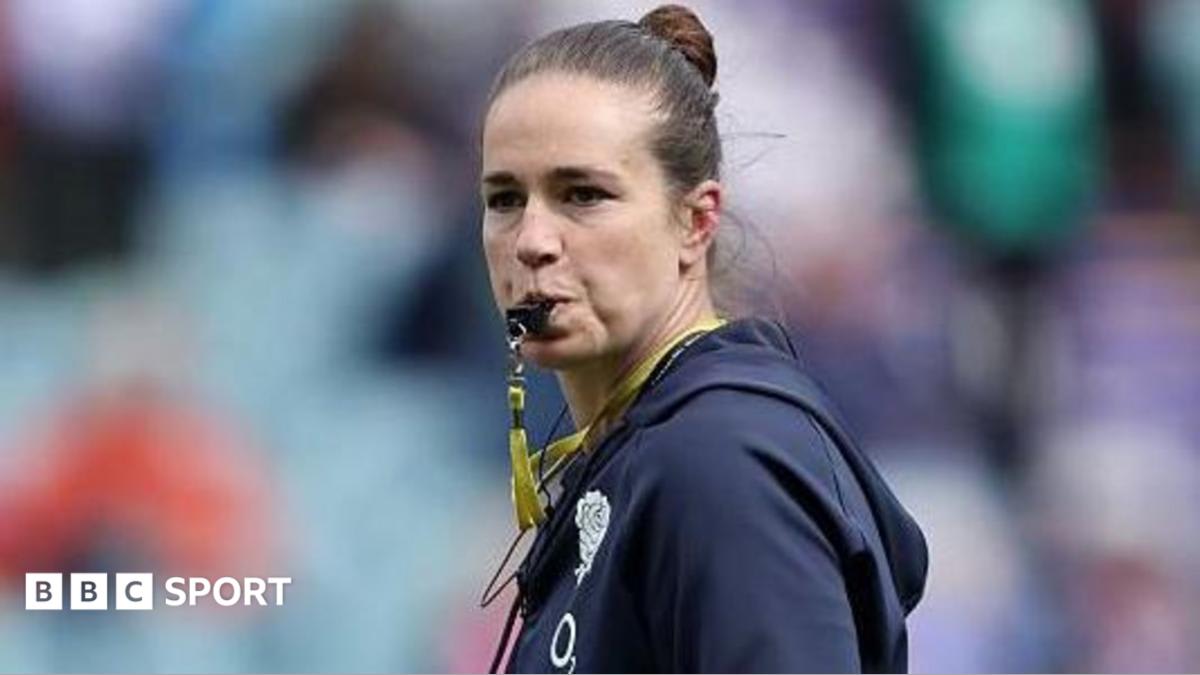 Emily Scarratt in England rugby coaching gear on the sideline during a match