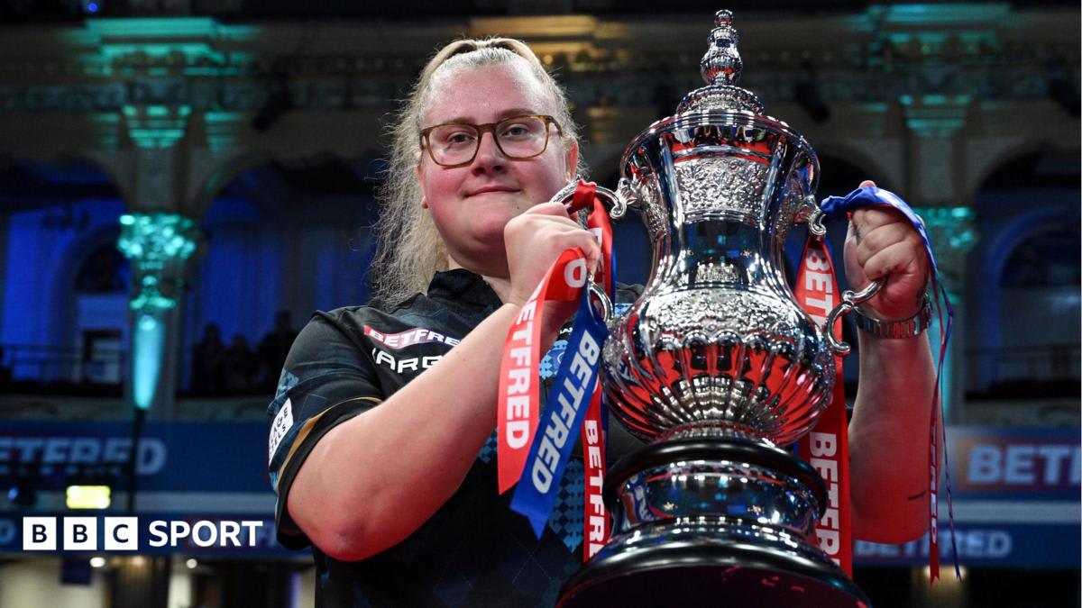 Beau Greaves celebrating with trophy after winning Women's World Matchplay at Blackpool Winter Gardens