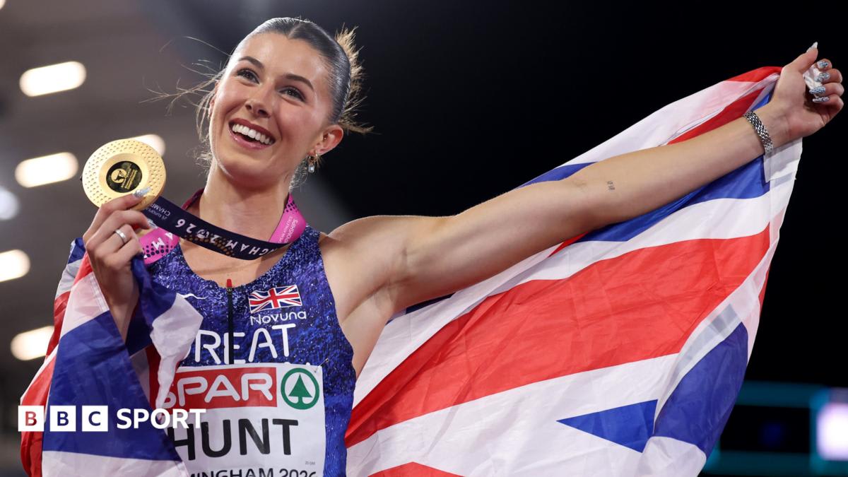British sprinter Amy Hunt celebrating with arms raised after winning 100m gold medal at European Championships