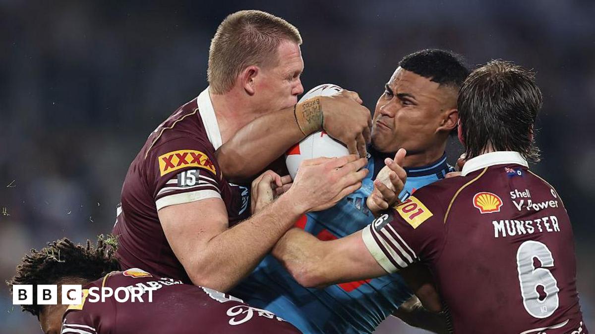 Rugby league players competing in State of Origin match with aggressive defensive play