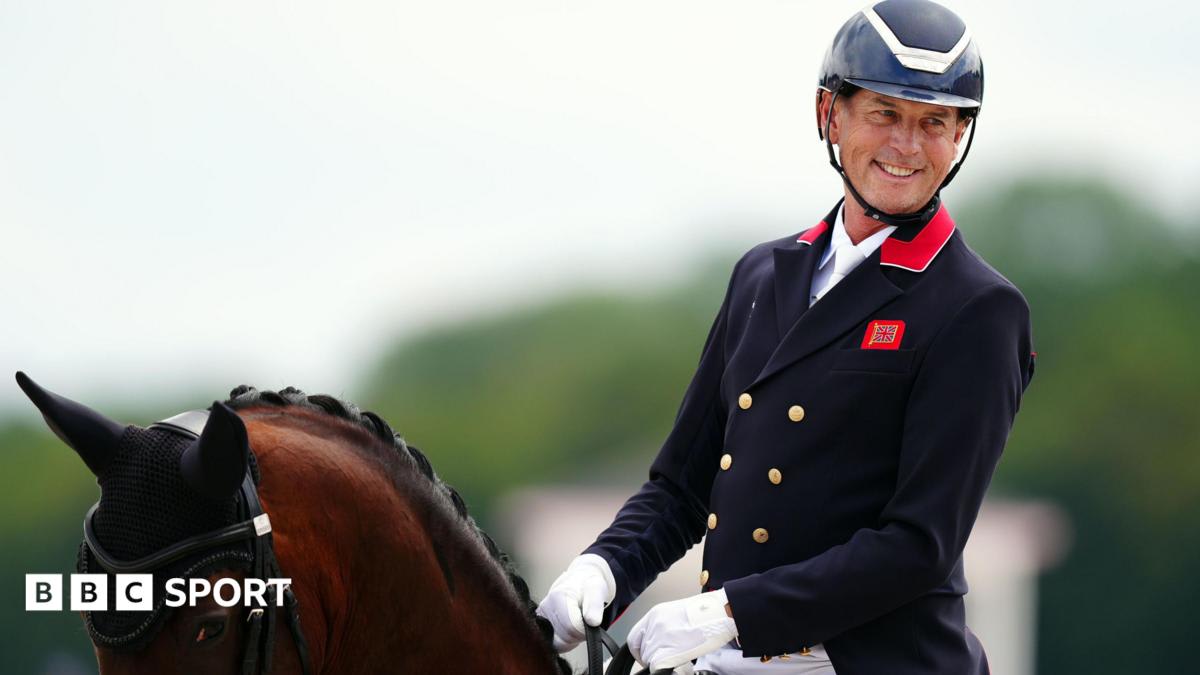 Carl Hester in formal dressage attire sitting on horseback during Olympic competition