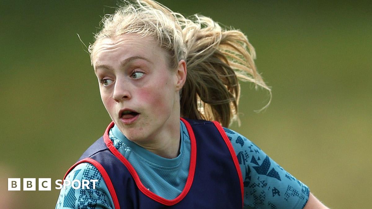 Young rugby player Millie David in Bristol Bears uniform running with ball during match