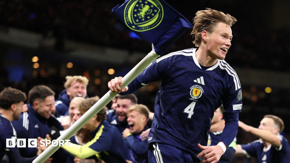 ** Scott McTominay wearing Scotland jersey speaks to young teammates during training session
