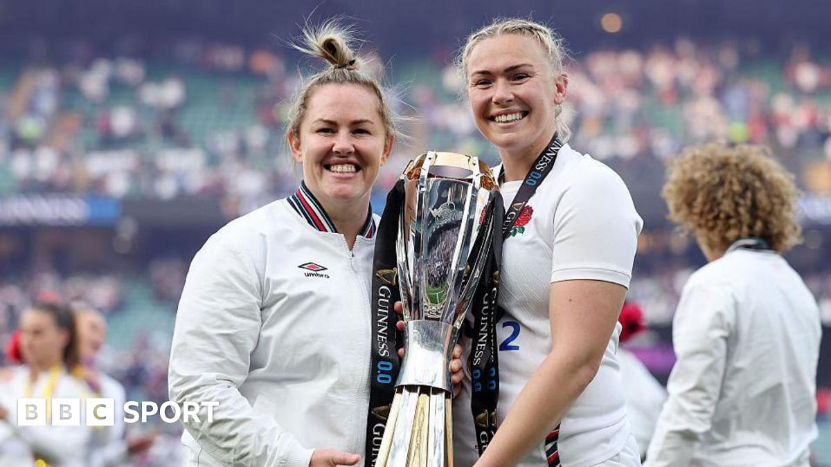 England rugby players Rosie Galligan and Marlie Packer celebrating together on field in red jerseys