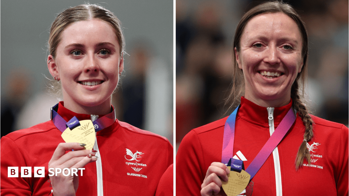 Emma Finucane and Anna Morris holding Commonwealth Games gold medals while smiling at camera