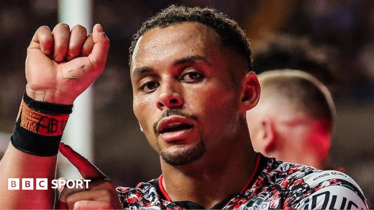 Leigh Leopards rugby players celebrate defensive stand against Leeds Rhinos on field