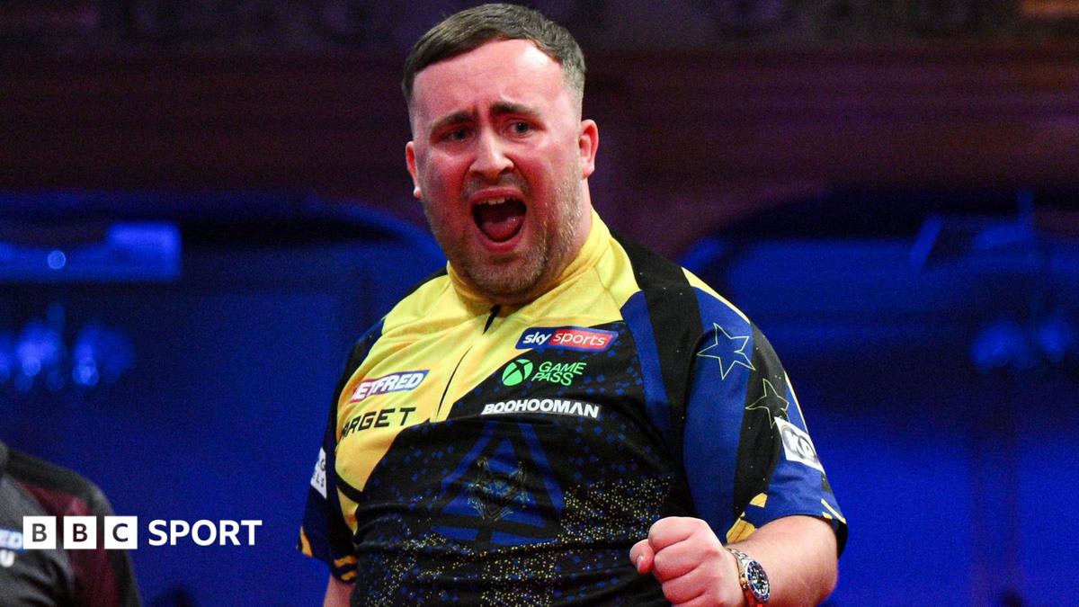Young darts player Luke Littler celebrates throwing perfect nine-darter at World Matchplay tournament