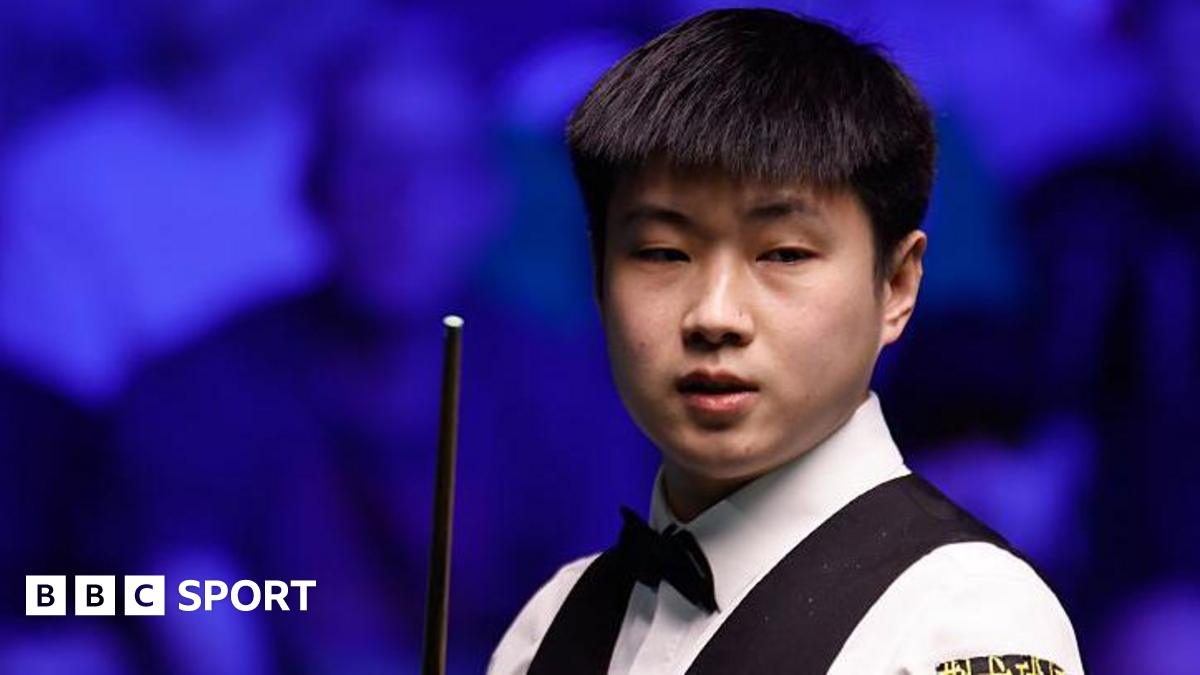 Zhao Xintong holding Tour Championship trophy after defeating Judd Trump in Manchester