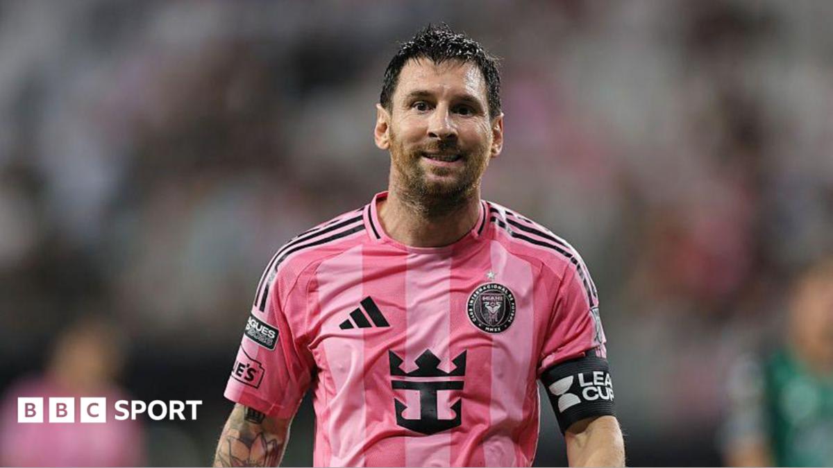 Lionel Messi in Inter Miami uniform walking onto soccer field during match