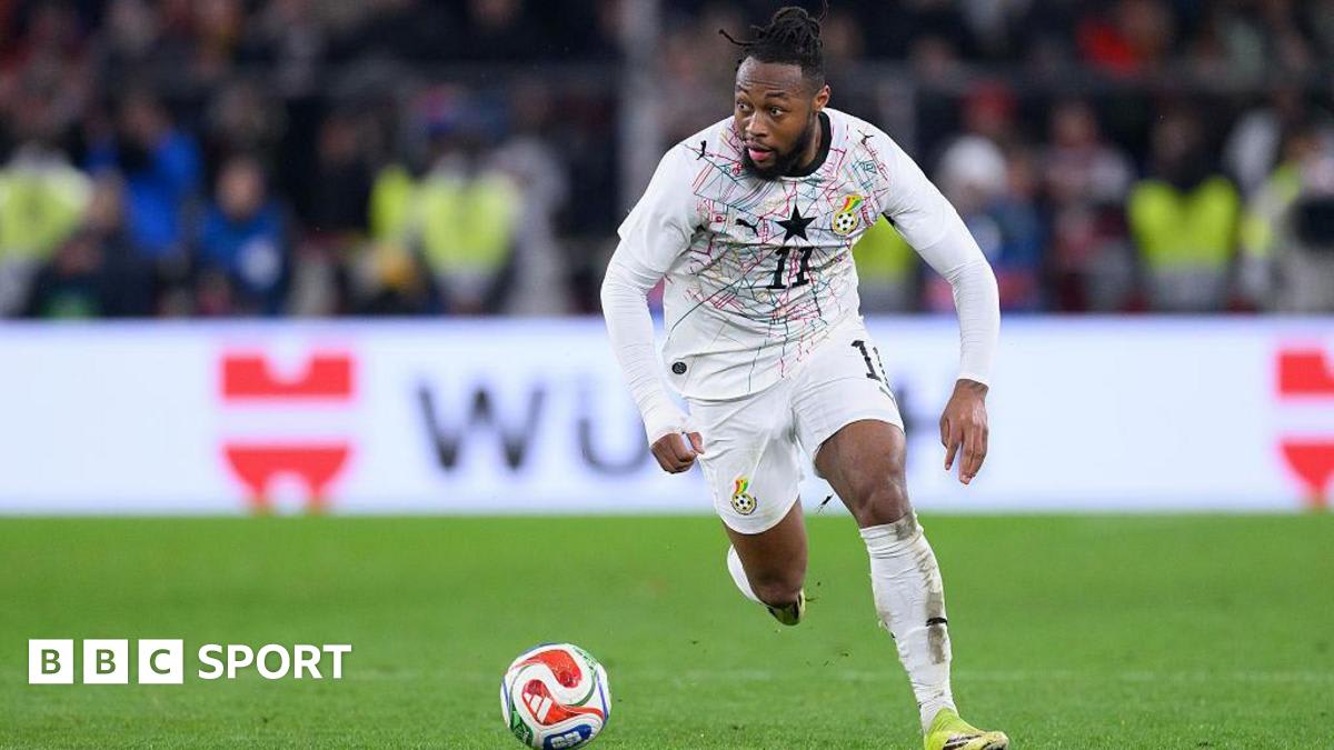 Antoine Semenyo in Ghana national team jersey running with the ball during international match