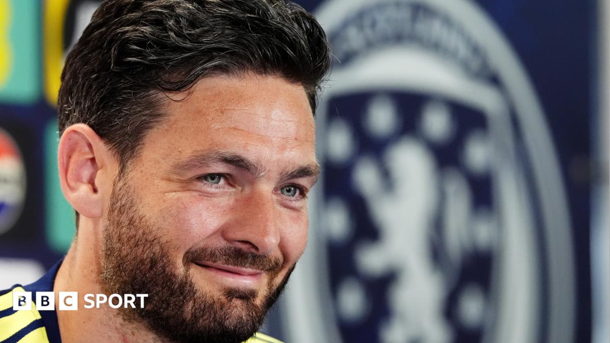 Scotland goalkeeper Craig Gordon in green jersey preparing for 2026 World Cup match