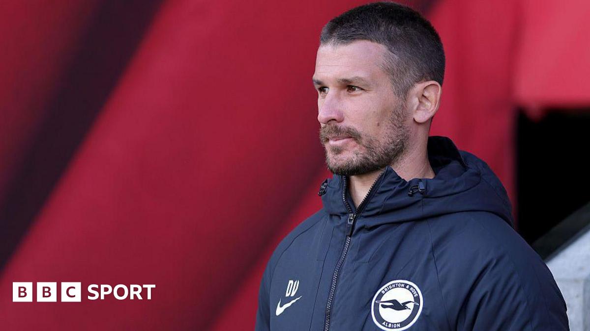 Brighton women's football manager Dario Vidosic standing on sideline during match in team colors