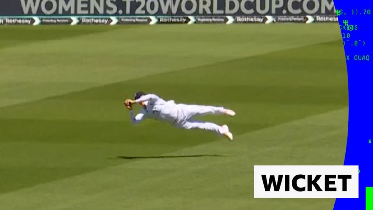 ** Young cricket player Jacob Bethell diving horizontally through air making spectacular catch at Oval