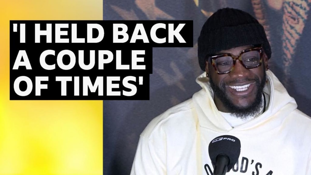 Deontay Wilder and Derek Chisora in boxing ring showing mutual respect after their match