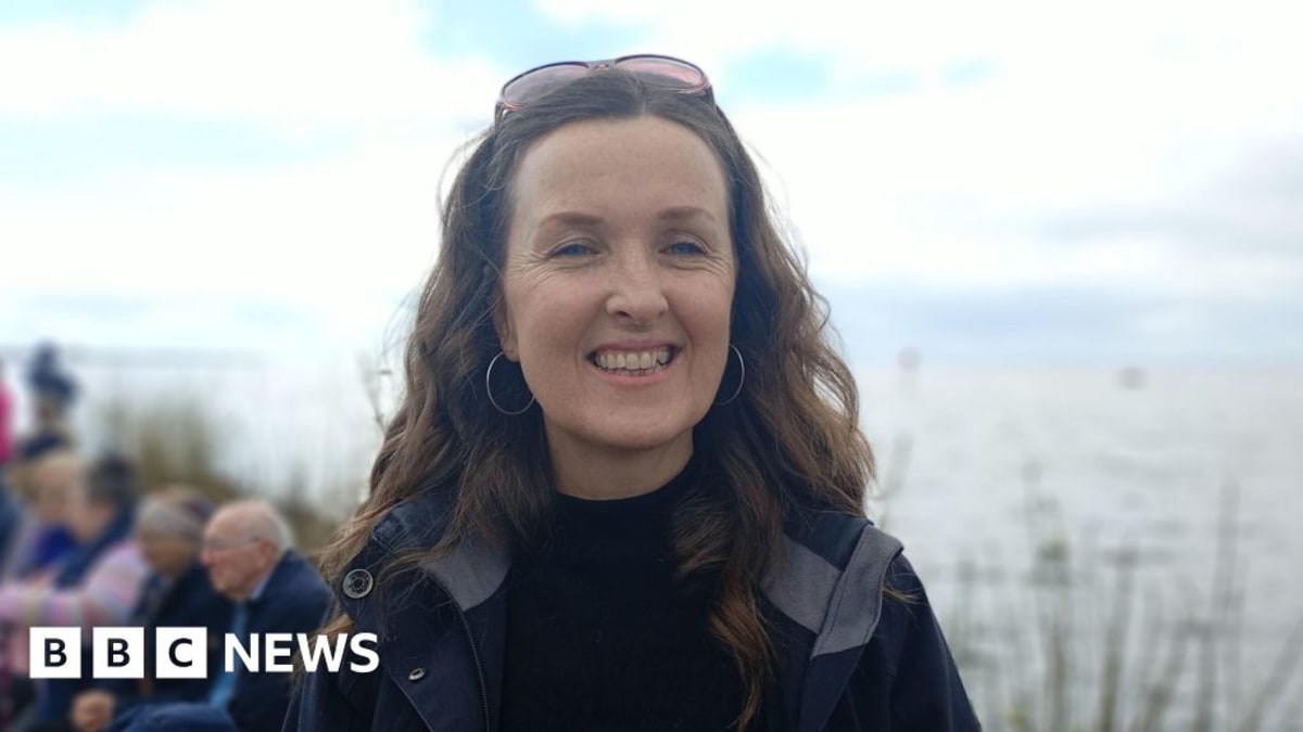 Community choir members singing together along the shores of Lough Neagh in Northern Ireland