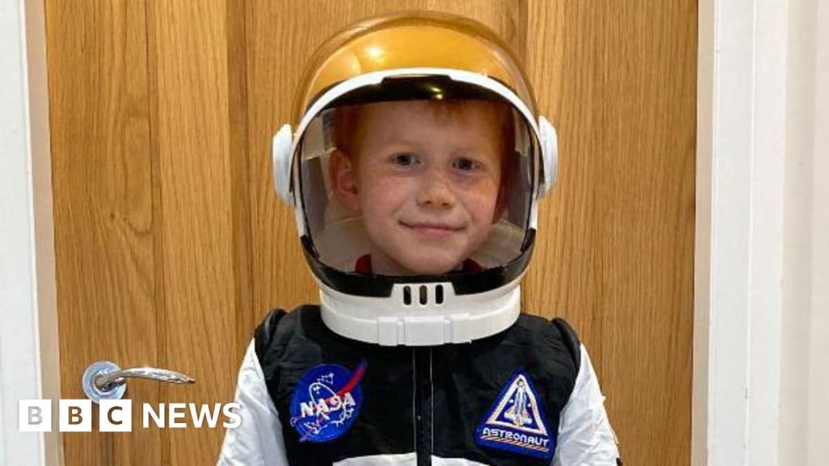 Young boy Efan Dafydd smiling at camera, wearing casual clothing, passionate astronomy enthusiast