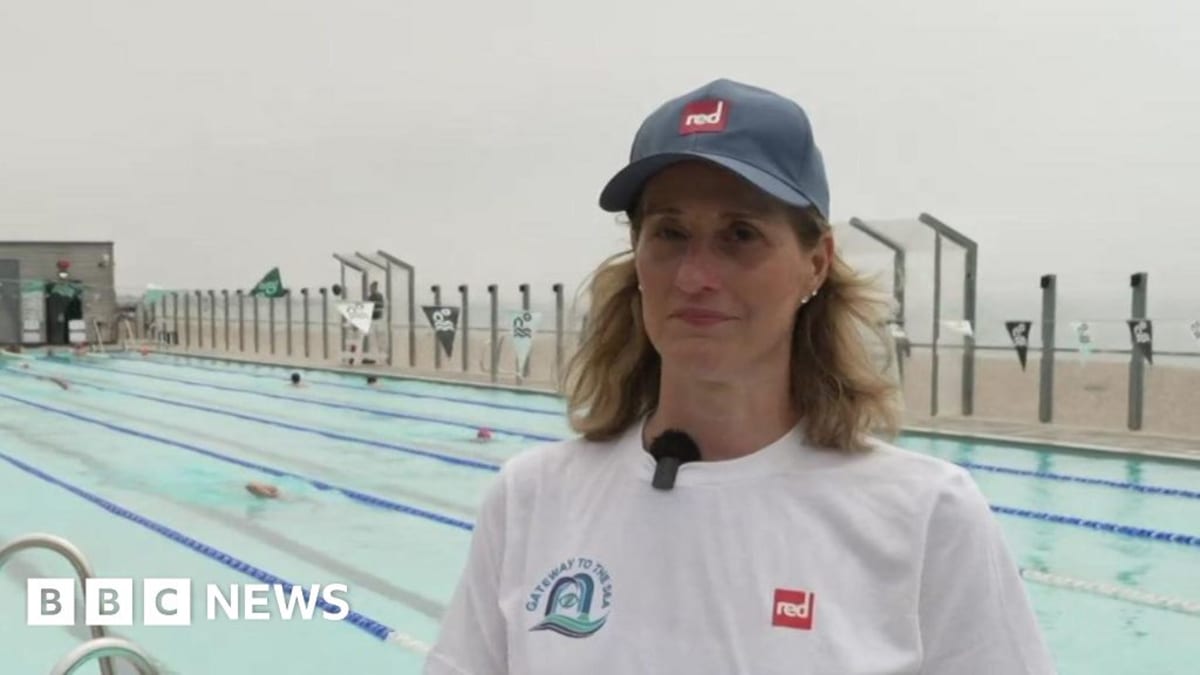 Paralympic champion swimmer Melanie Barratt smiling in swimming gear at Brighton beach