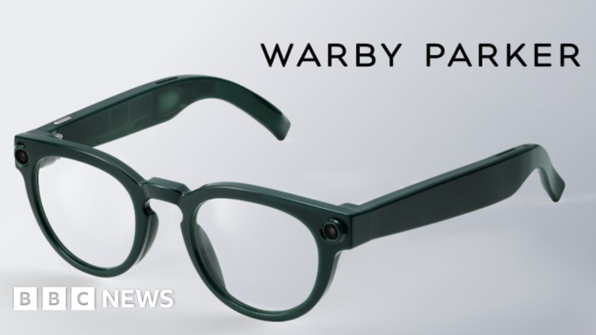 Person wearing sleek smart glasses with built-in camera and speakers for AI assistance