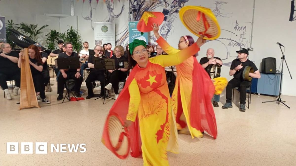 Musicians from diverse backgrounds playing traditional instruments together at Belfast's Irish music festival