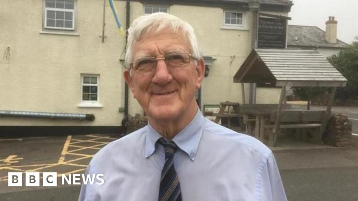 Eric Norman standing outside Rest and Be Thankful Inn in Somerset countryside