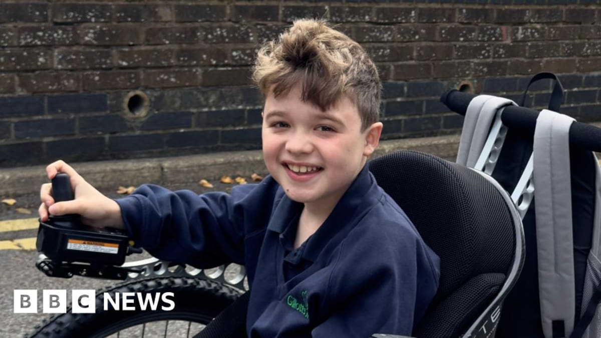 Young boy Ben smiling outdoors with his father Alex who campaigned for muscle disease treatment access