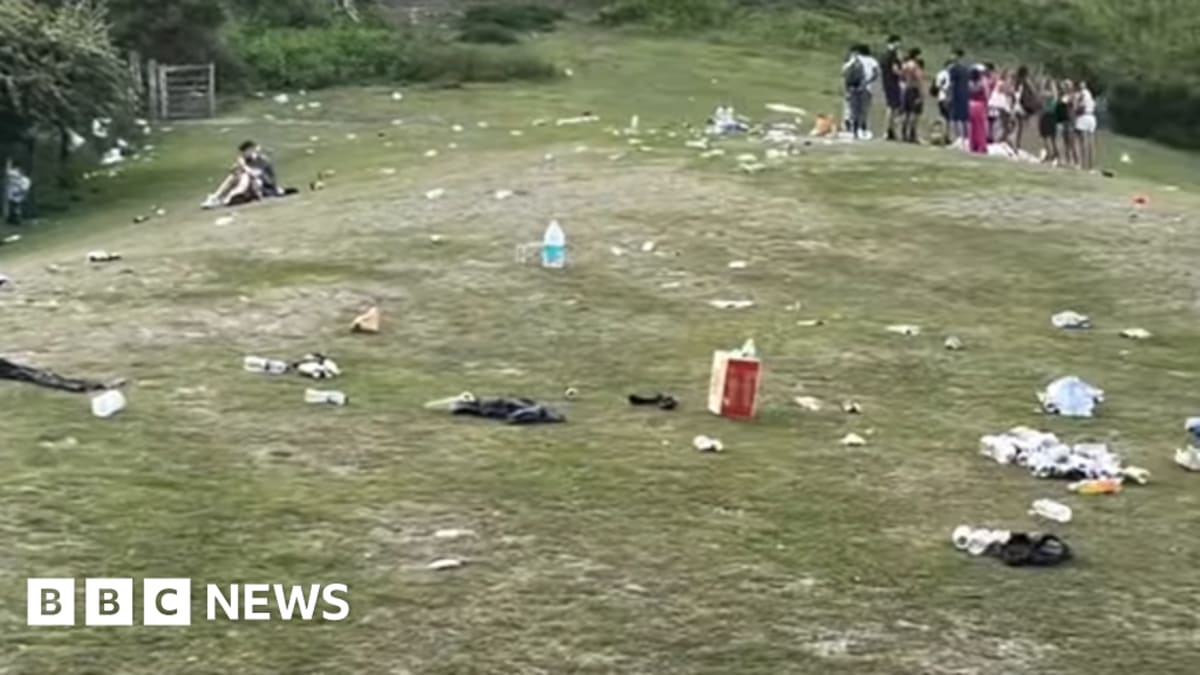 Volunteers collecting bags of litter from hillside at Carding Mill Valley in Shropshire