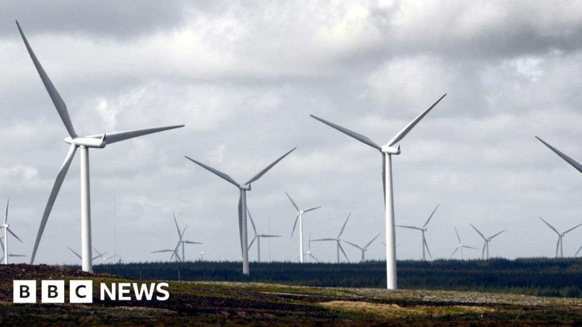Modern white wind turbines standing tall against moorland landscape near Glasgow, Scotland