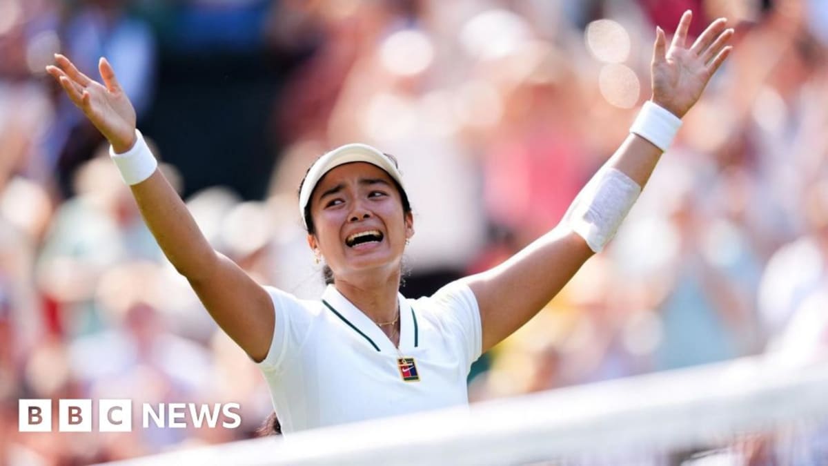 Alex Eala celebrating on tennis court in white outfit with racket raised