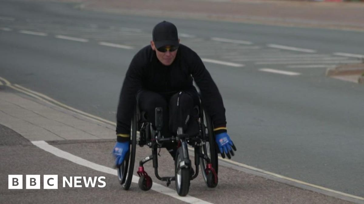 Lexi Chambers in wheelchair training along Exmouth seafront preparing for Alpe d'Huez challenge