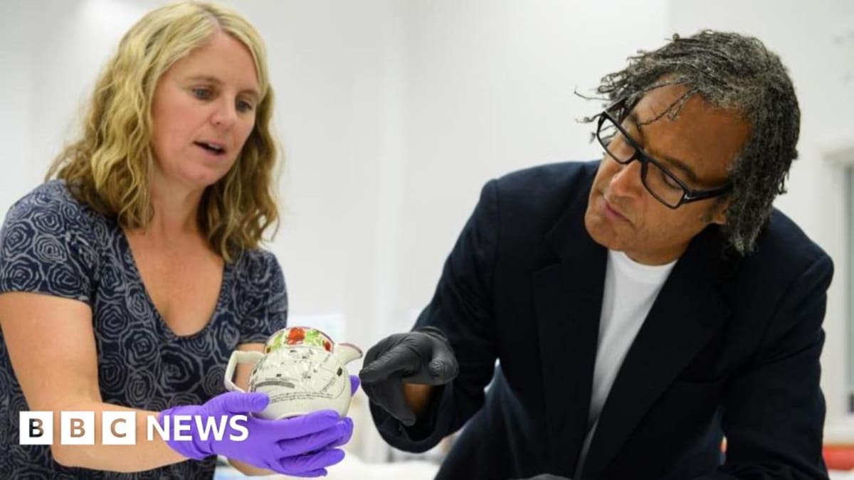 Historian David Olusoga examining rare Peterloo commemorative jug at People's History Museum Manchester