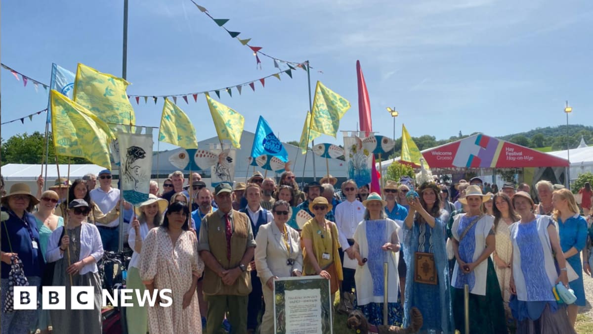 Hundreds of supporters gather along the River Wye during the historic charter signing ceremony