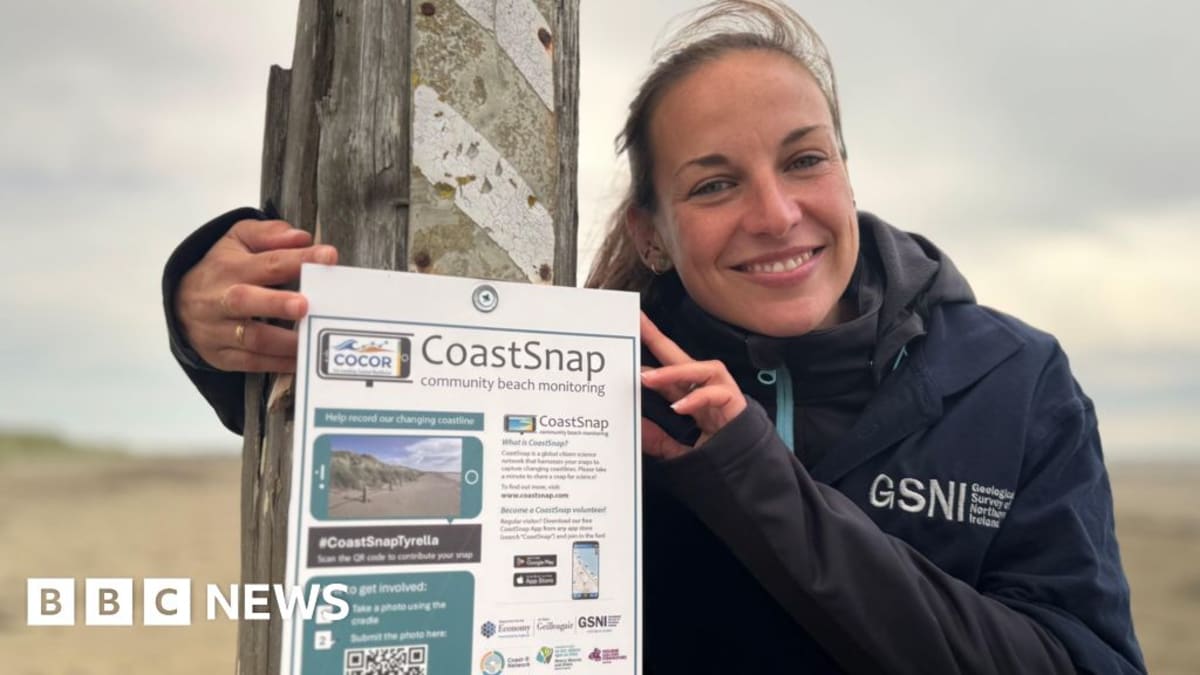 Steel smartphone cradle mounted on beach fence post frames coastal view for citizen science photos